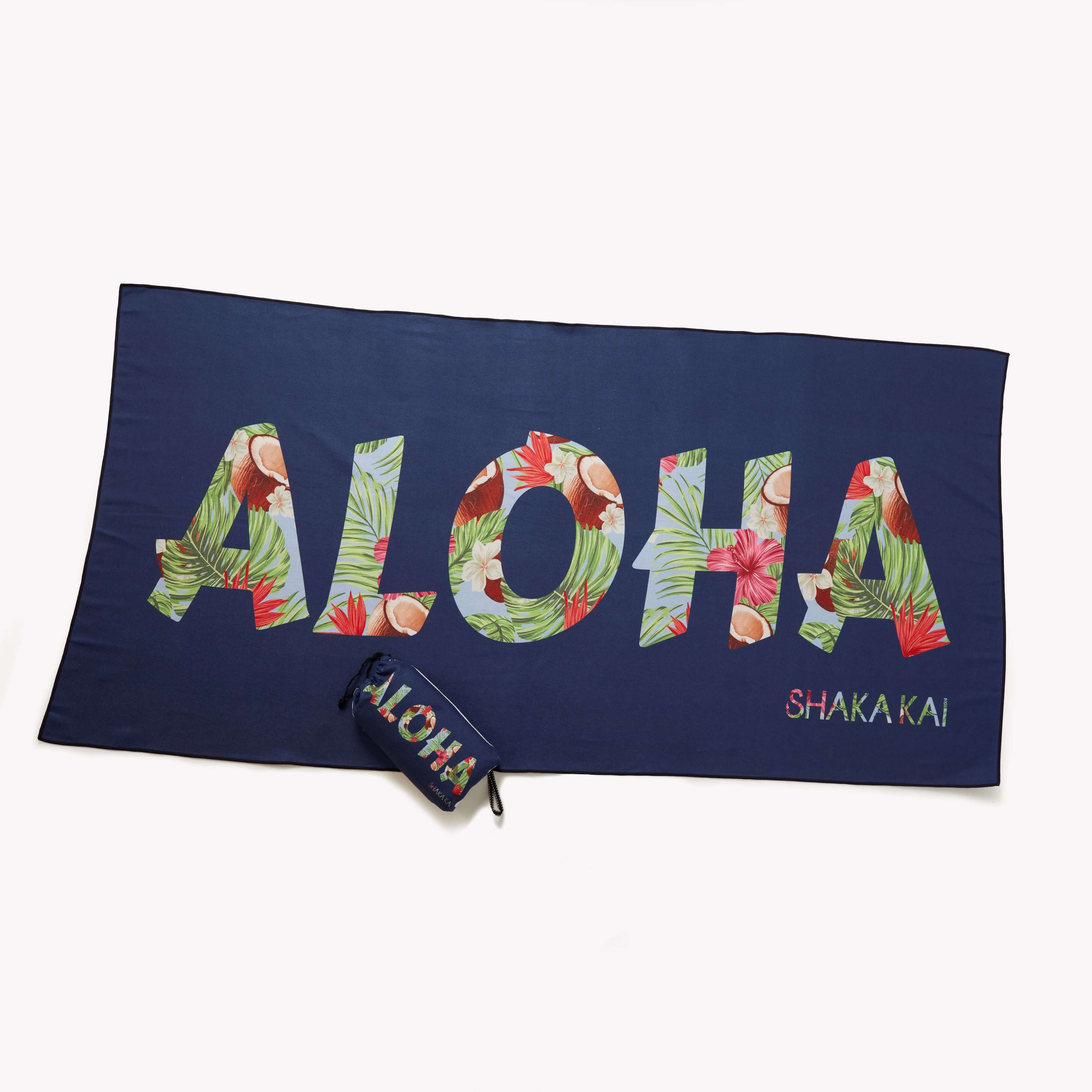 Oversized Aloha Micro Fiber Towel laid out with colorful floral design and matching pouch.