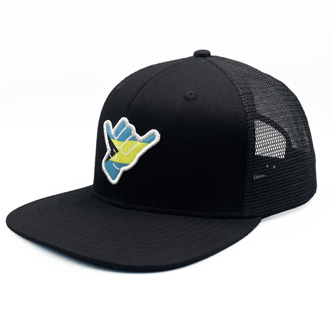 Black trucker cap with a colorfu Shaka bahamas themed logo with a mesh back on a white background