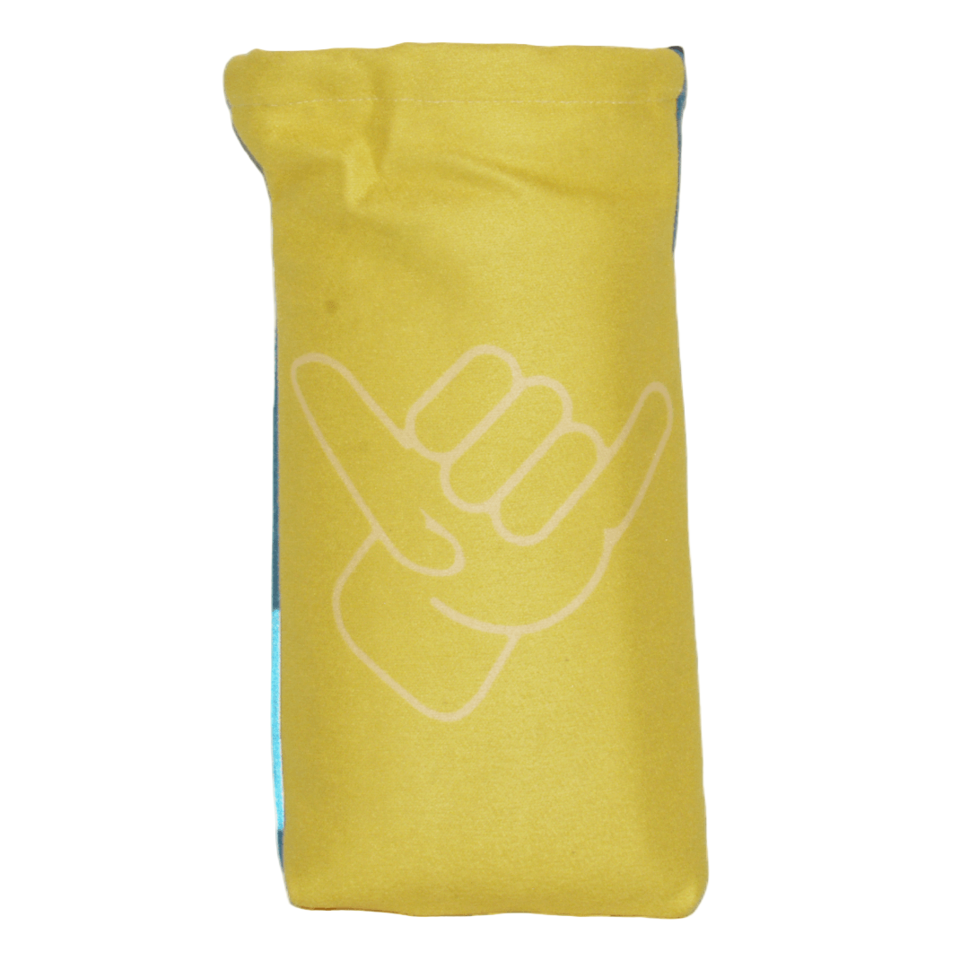 Yellow oversized towel with a white Shaka hand gesture design on a white background