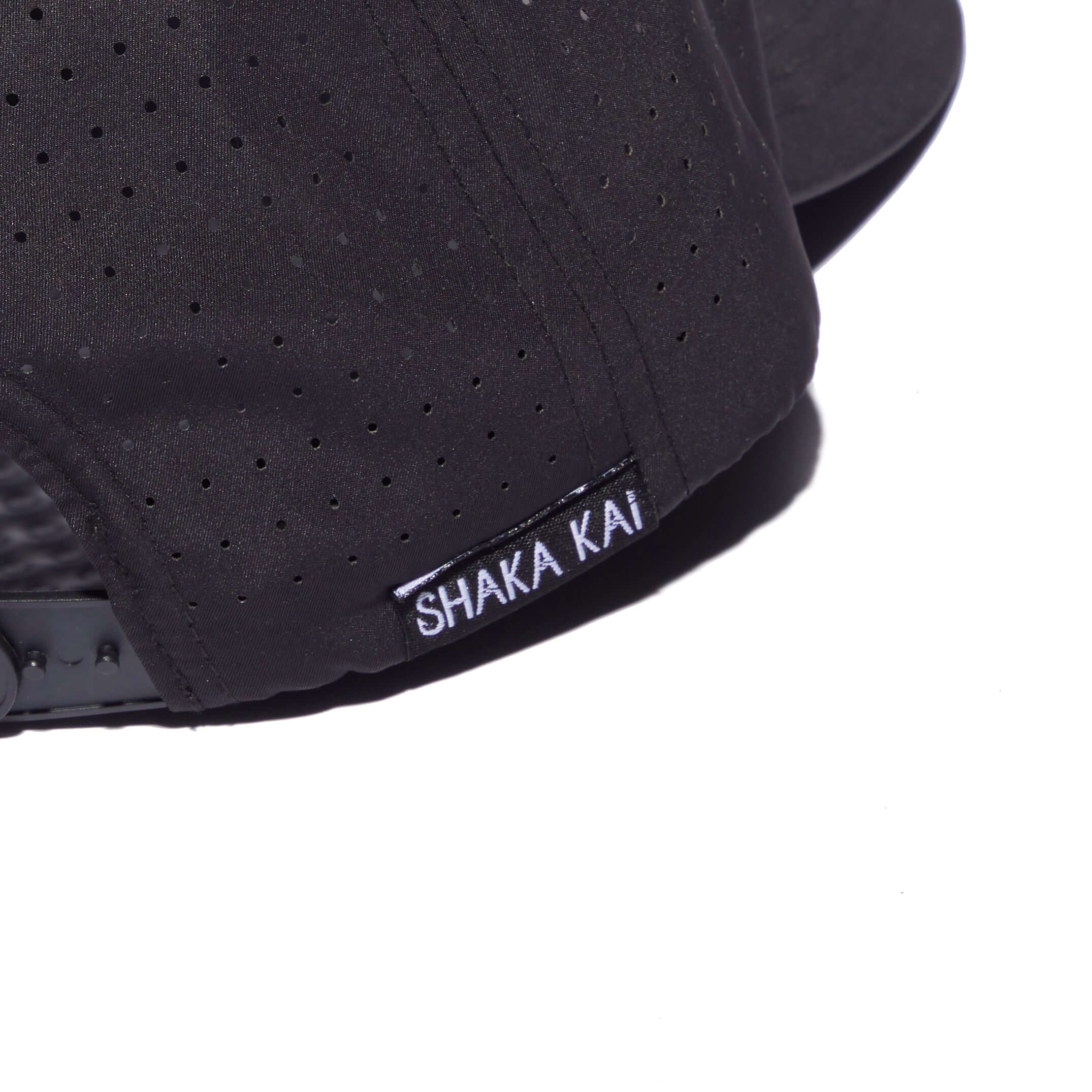 Close-up of DaveL Shaka-Shimi Mahi Ultra Fit hat showcasing the Shaka Kai label and breathable fabric details.