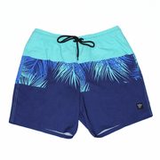 Blue and turquoise shorts with tropical leaf pattern on a white background