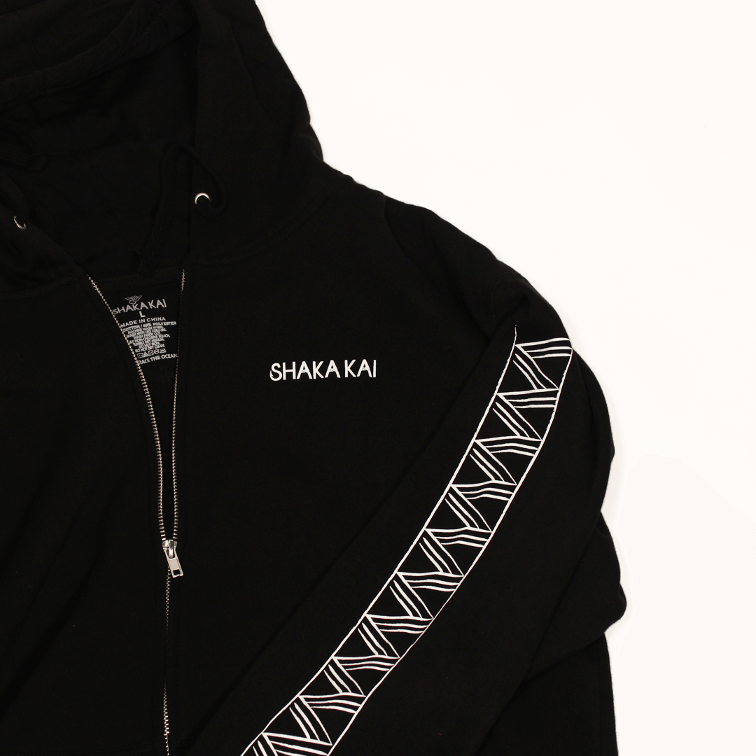 Niho Zip Hoodie featuring a sleek design with a black body and unique patterned detailing.