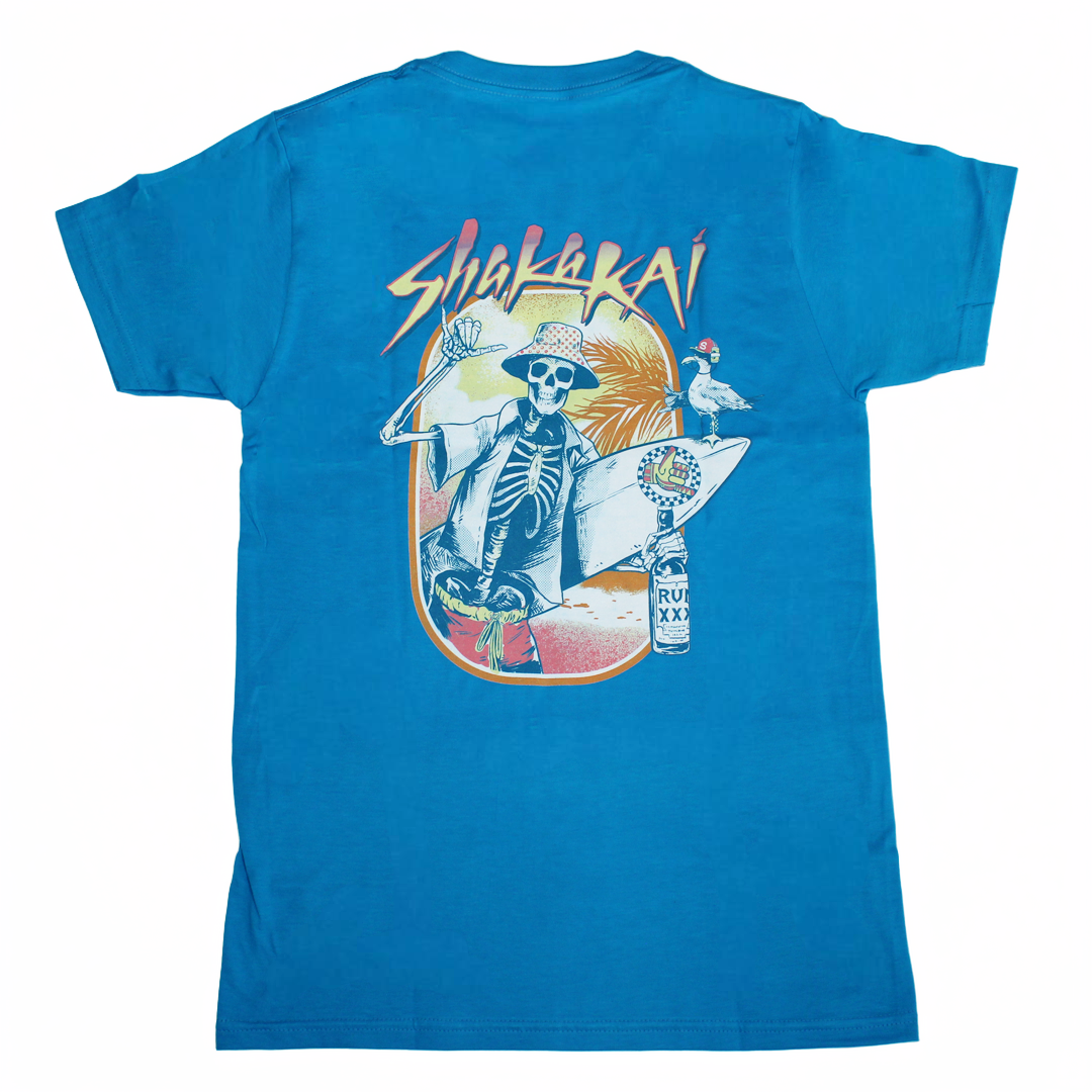 Drinking in Paradise T-Shirt featuring a colorful skeleton surfing design and tropical elements.