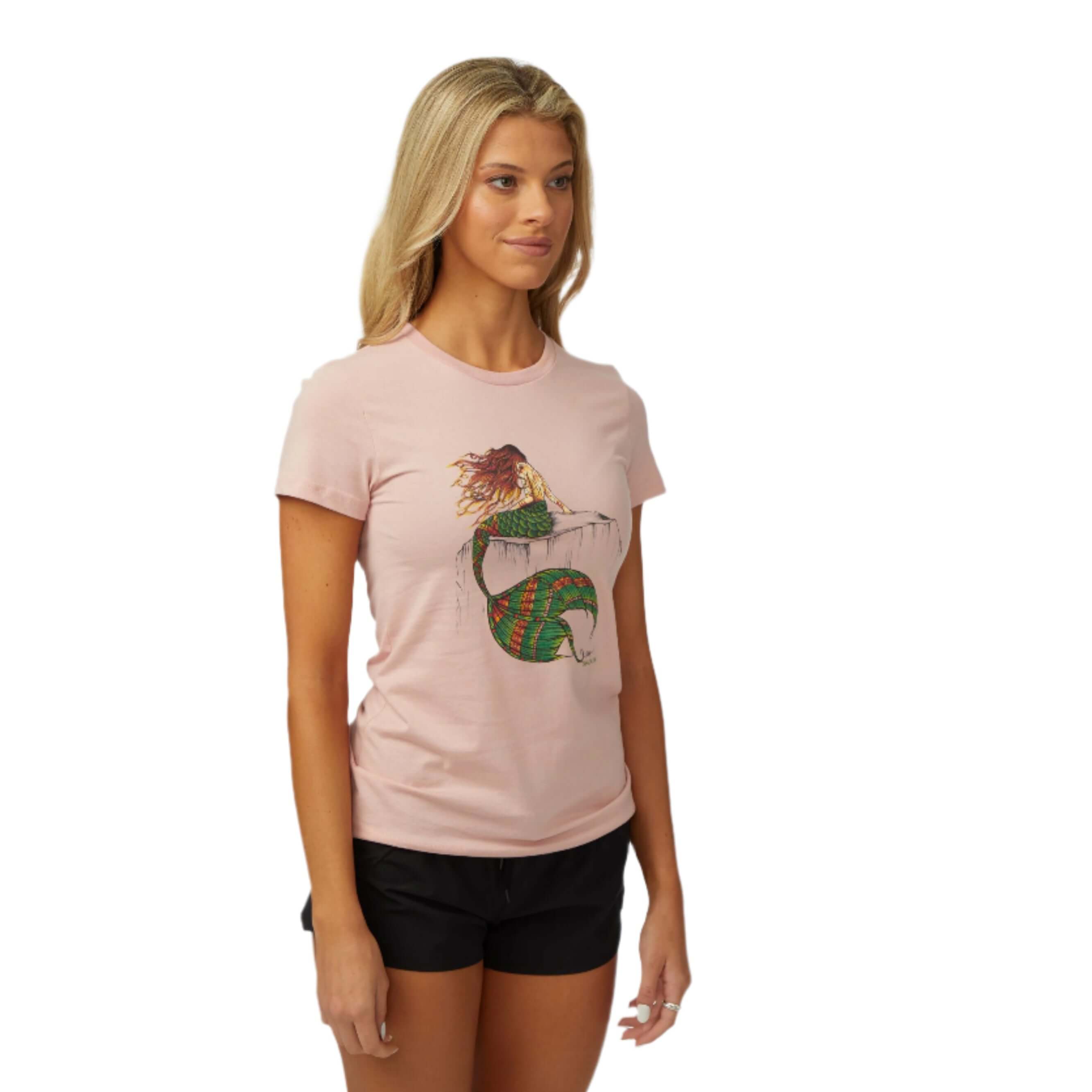 Woman wearing the DaveL Nixi T-Shirt featuring original island art, ideal for warm weather style.