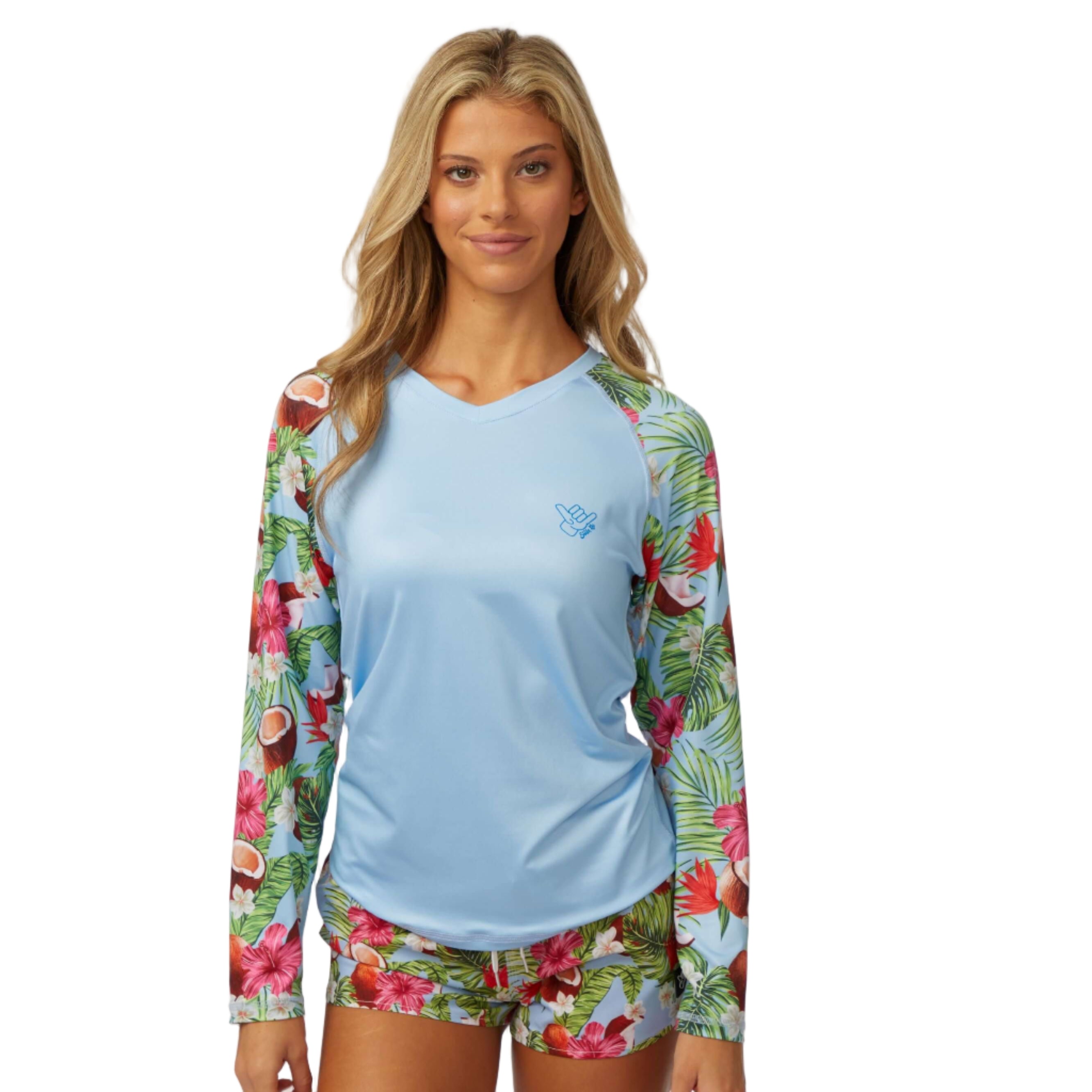 Coco Loco LS Performance Shirt UPF 50 worn by a model featuring floral sleeves and tropical design for sun protection.