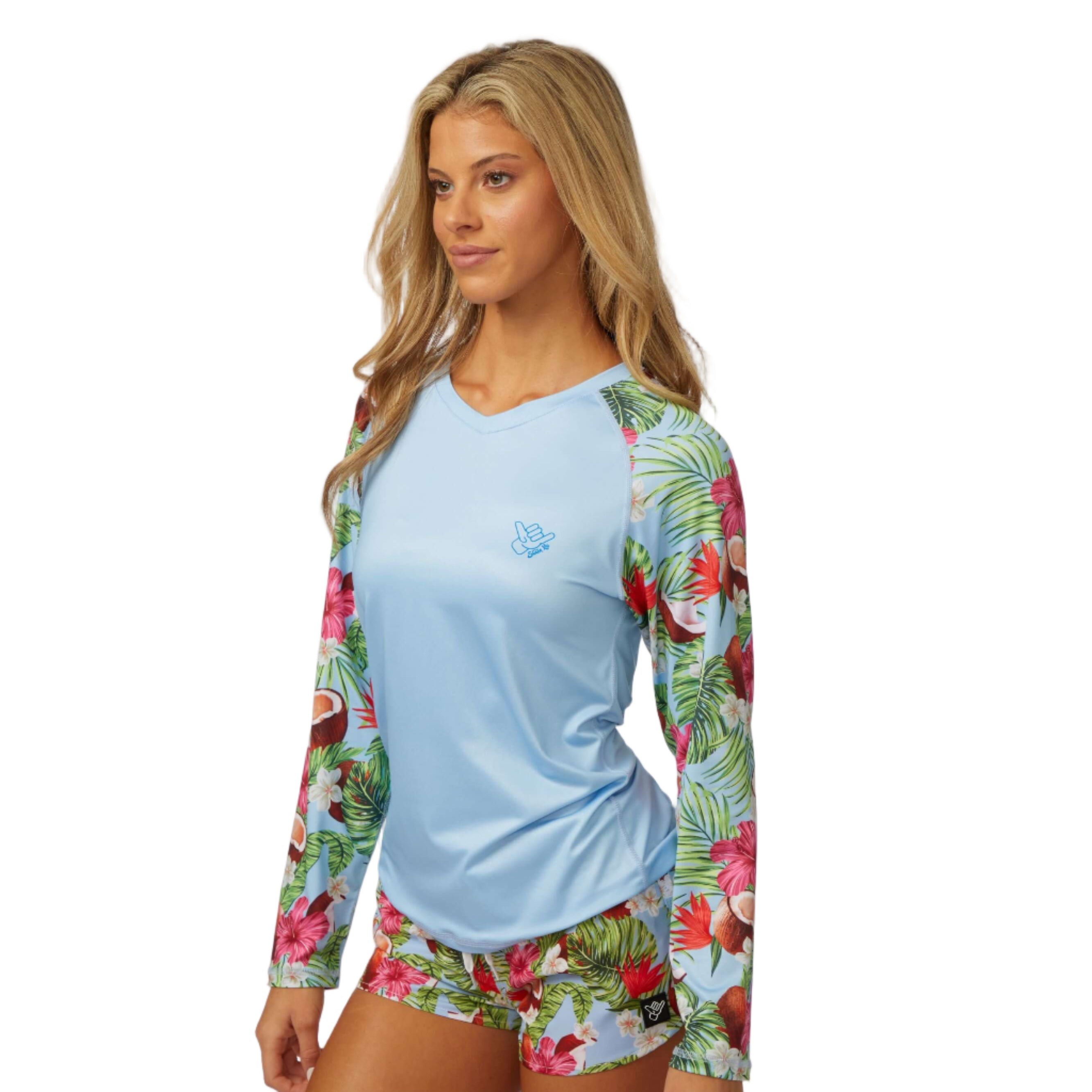 Coco Loco LS Performance Shirt UPF 50 with tropical print sleeves worn by a woman for sun protection and style.