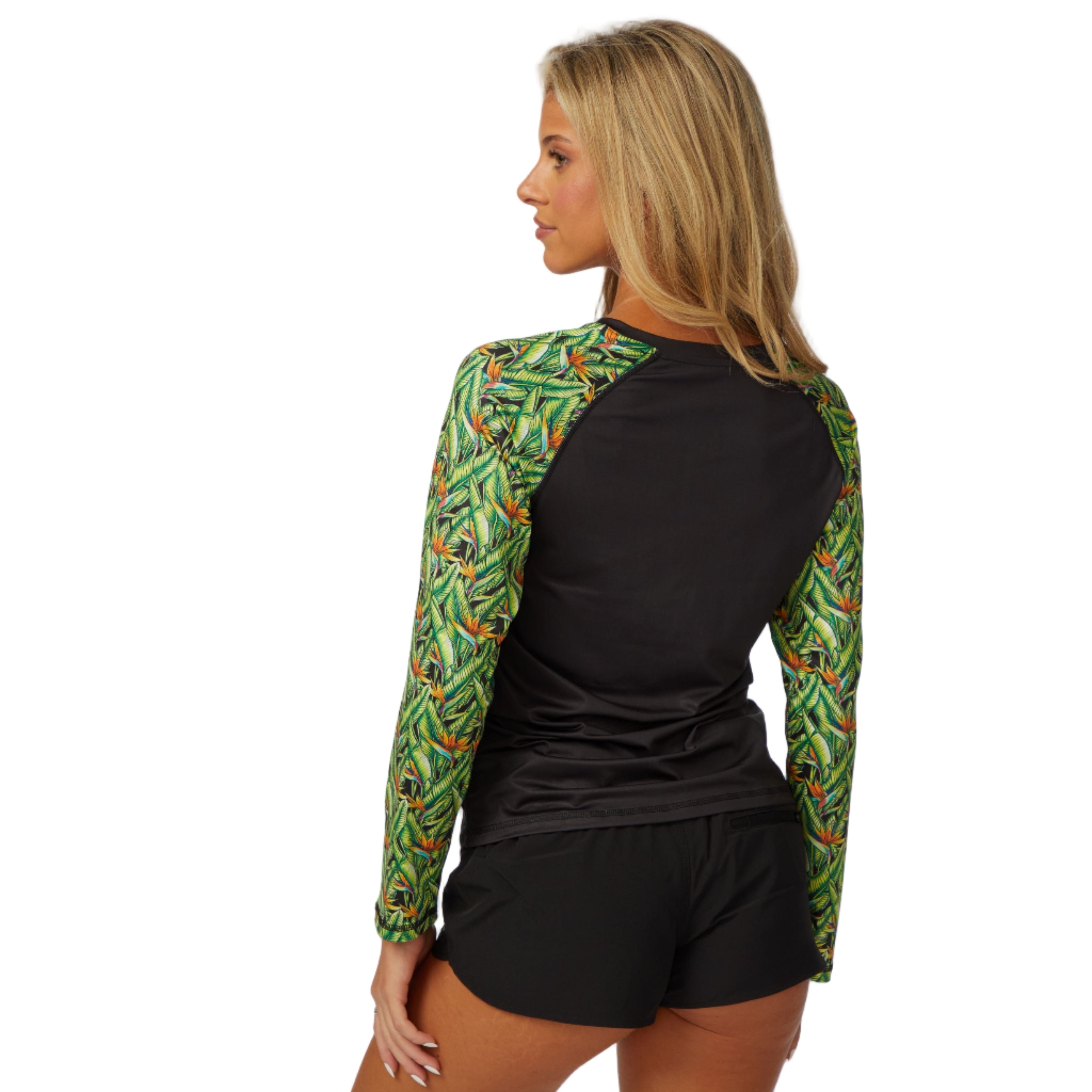 Woman wearing DaveL Manu LS Performance Shirt UPF 50 featuring vibrant green graphics and black body.