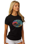 Woman wearing the DaveL Tranquil T-Shirt featuring a colorful wave design, perfect for warm weather and outdoor activities.