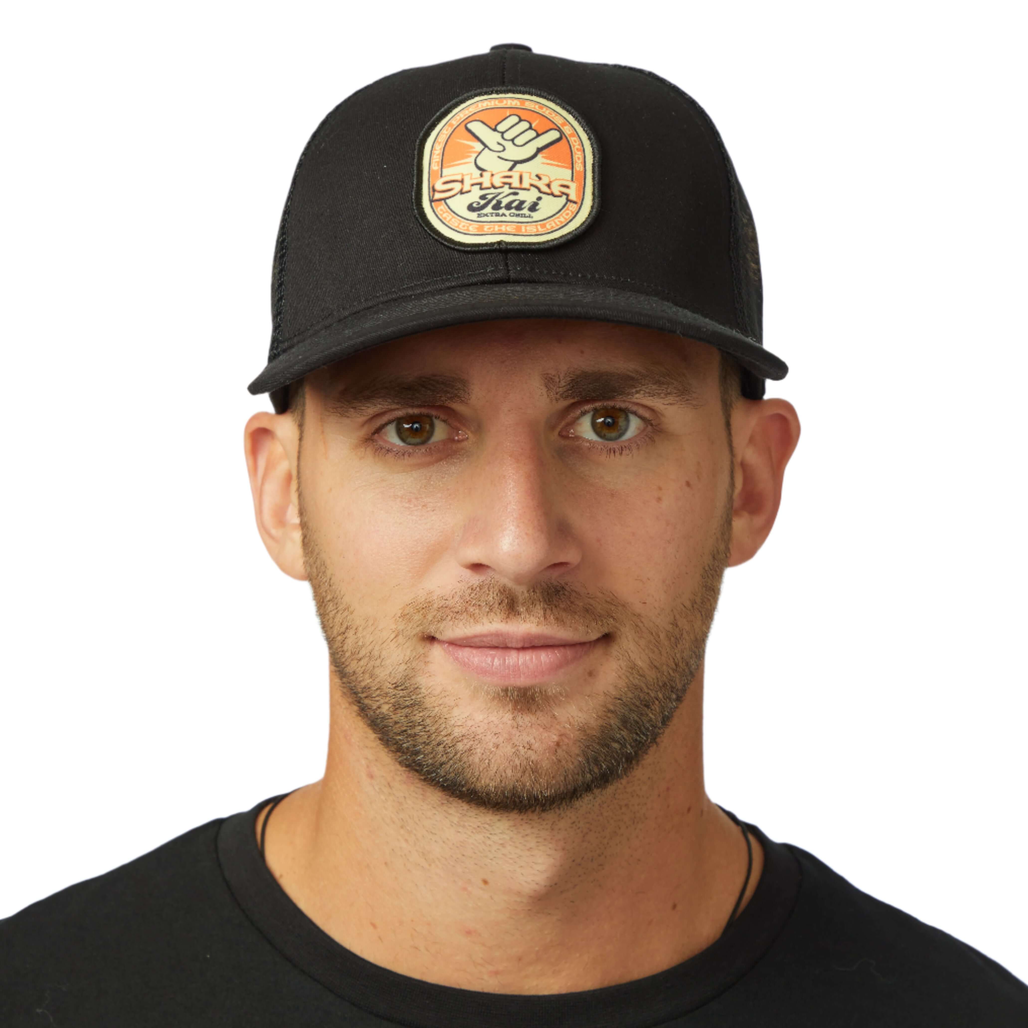 Stylish man wearing Suds & Duds Trucker Hat with bold patch and semi-curved visor, perfect for beach days.