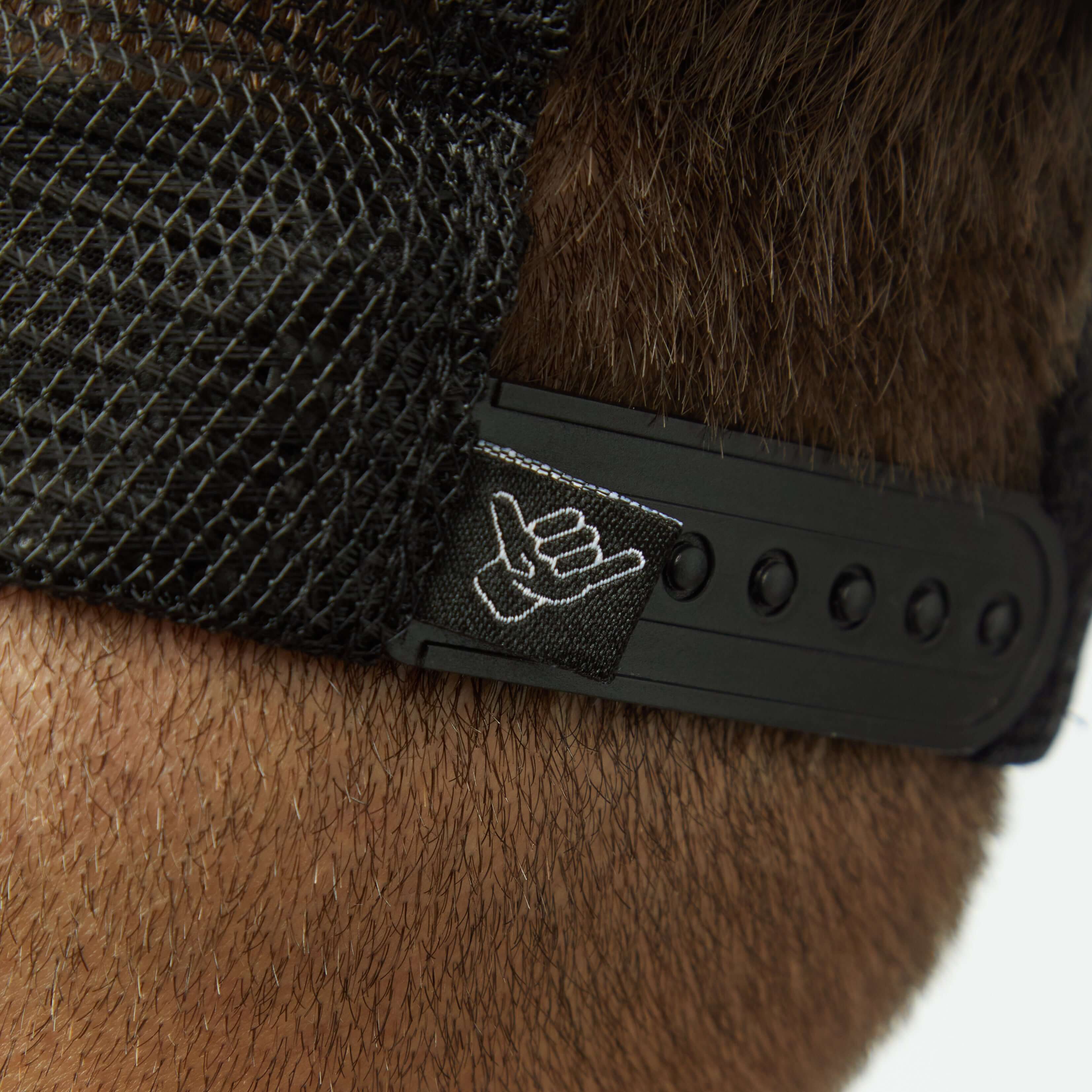 Close-up of the adjustable strap on the back of the Suds & Duds Trucker Hat showcasing its unique design.